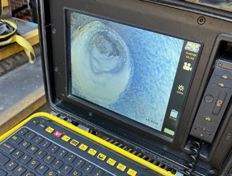 CCTV drain camera showing the inside of a pipe while investigating a blockage in Fulham, London.