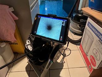 Checking a drain problem at the back of a shop office in London.