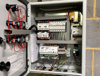 Diagnosing electrical faults inside a sewage pump control board.