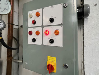 Older pump control unit undergoing safety checks and testing.