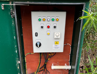 Control panel within outdoor chamber cleaned and serviced for safe operation.