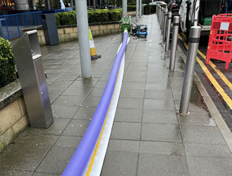 The pre-prepared drain liner being pulled into position along the pipe run.