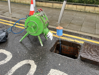 Setting up specialist drain relining equipment ready for installation in Harlow, Greater London.