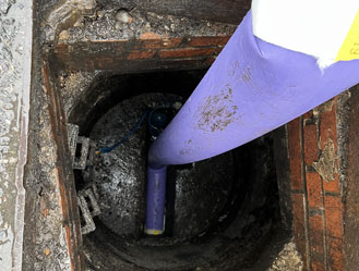 Close-up of the liner being inserted into the pipe chamber before inflation.