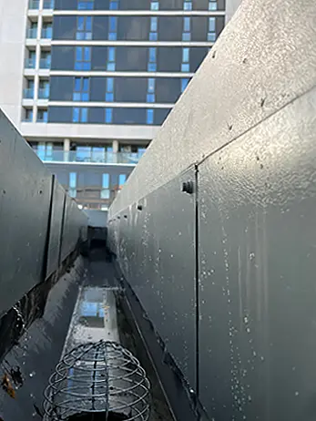 A gutter emptied of debris and cleaned, ready for use