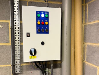 Jet and Drain engineer servicing a sewage pump station control panel in London.