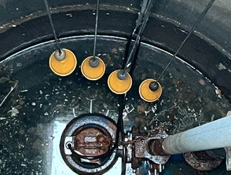 Float switches and sewage pump system being inspected and serviced by a Jet and Drain engineer.